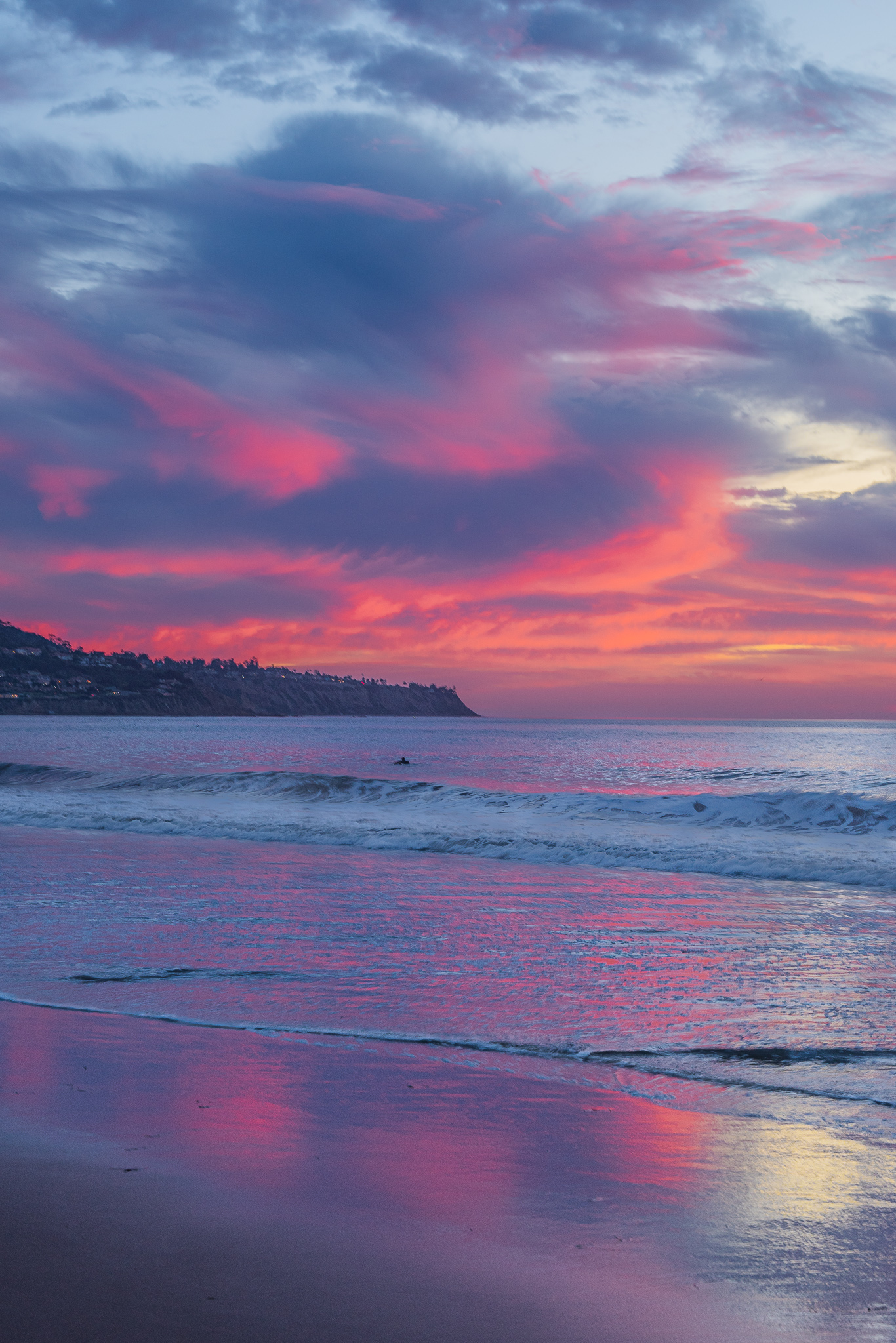 Cloudy and colorful winter sunset at The Burnout in Redondo Beach, California overlooking the hills of Palos Verdes
